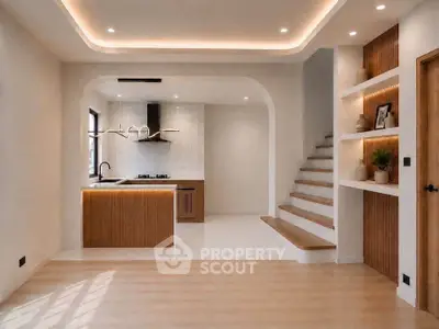 Modern open-plan living room with stylish kitchen and elegant staircase