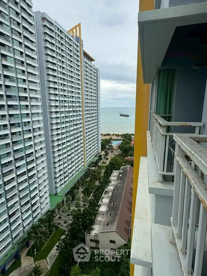 Stunning ocean view from high-rise balcony in modern residential building.