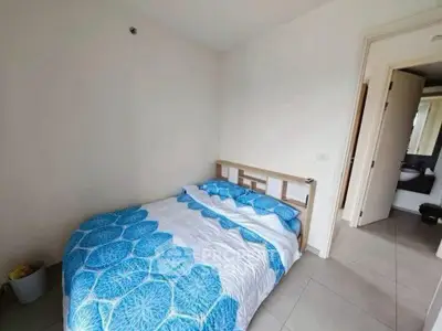 Cozy bedroom with blue floral bedding and en-suite bathroom access