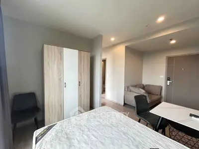 Modern bedroom with stylish furniture and cozy seating area