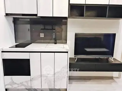 Modern kitchen with sleek cabinetry and integrated appliances in a stylish apartment.