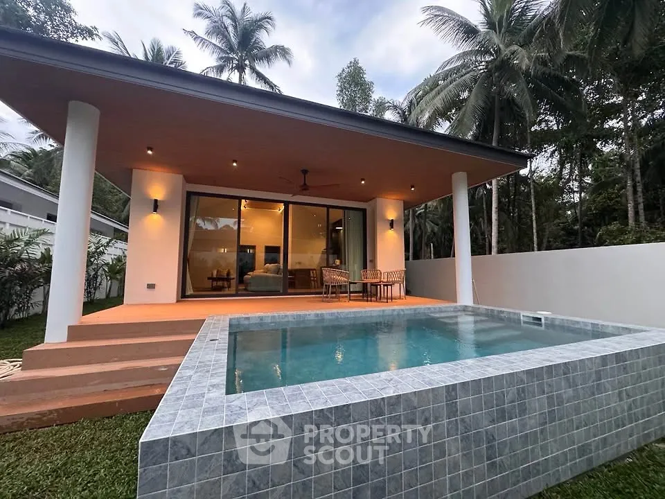 Stunning modern villa with private pool and spacious terrace surrounded by lush greenery.