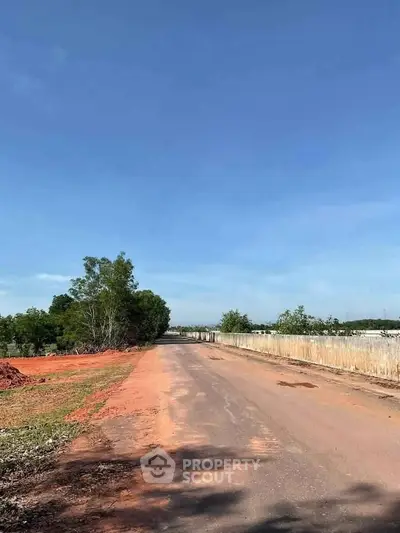 Expansive land plot with clear skies, ideal for development opportunities.
