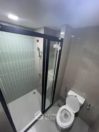 Modern bathroom with glass shower enclosure and sleek tile design