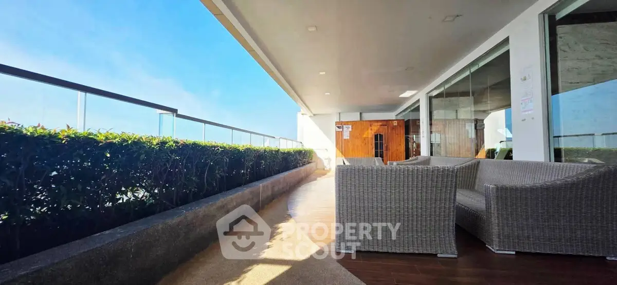 Spacious balcony with modern seating and stunning view, perfect for relaxation and entertainment.