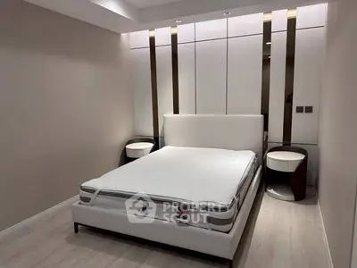 Modern bedroom with sleek design and elegant furniture, featuring a comfortable bed and stylish nightstands.