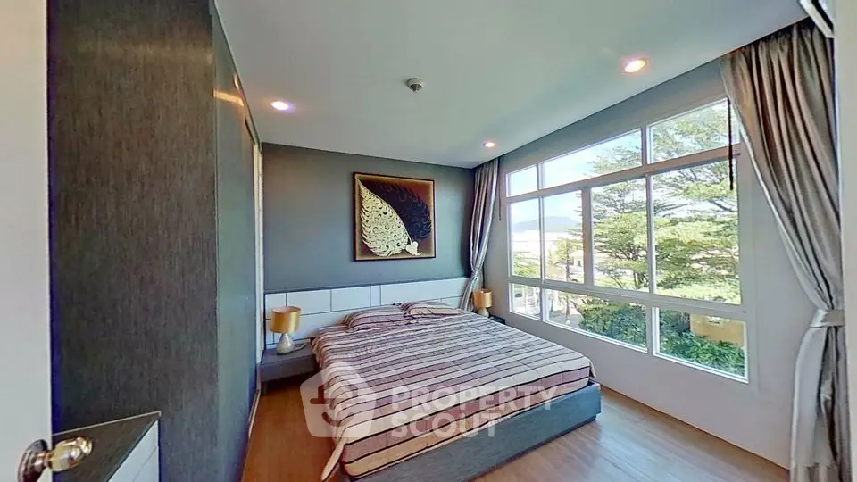 Spacious bedroom with large windows and elegant decor