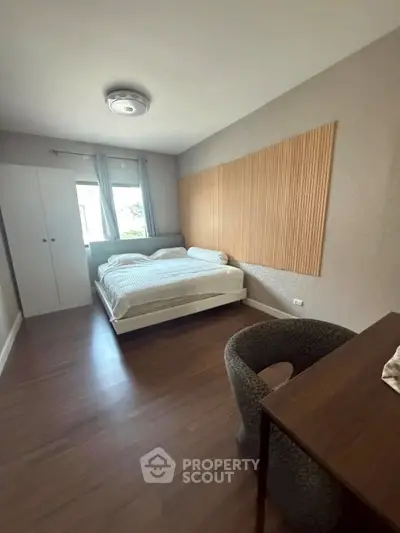 Cozy bedroom with modern decor and ample natural light, featuring a comfortable bed and stylish furnishings.