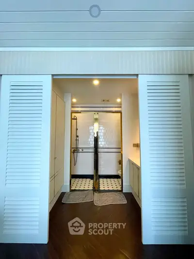 Luxurious bathroom with sliding doors and elegant tile design