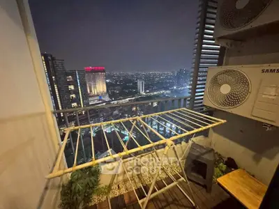 Stunning city view from a high-rise balcony with air conditioning units and drying rack.