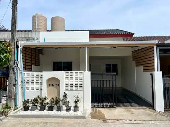 Charming single-story home with modern facade and spacious driveway in a quiet neighborhood.