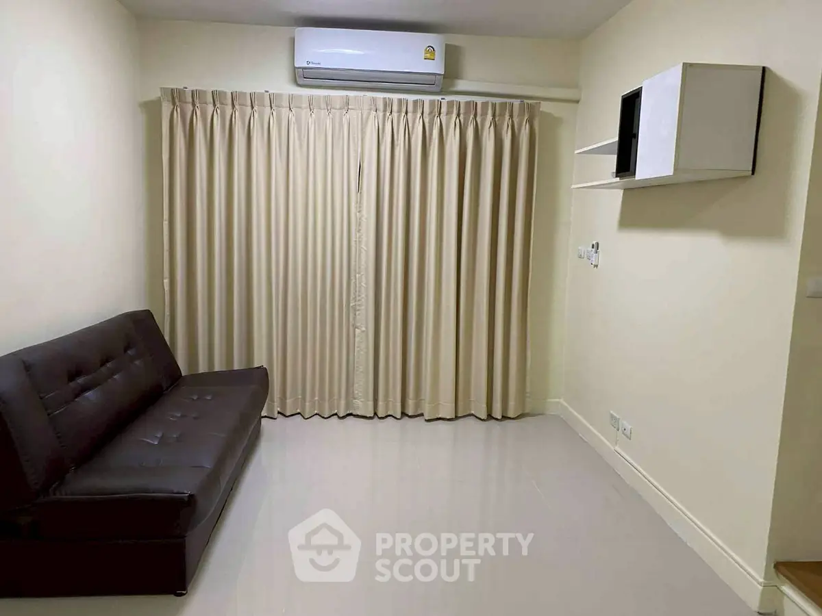 Modern living room with sleek sofa and air conditioning