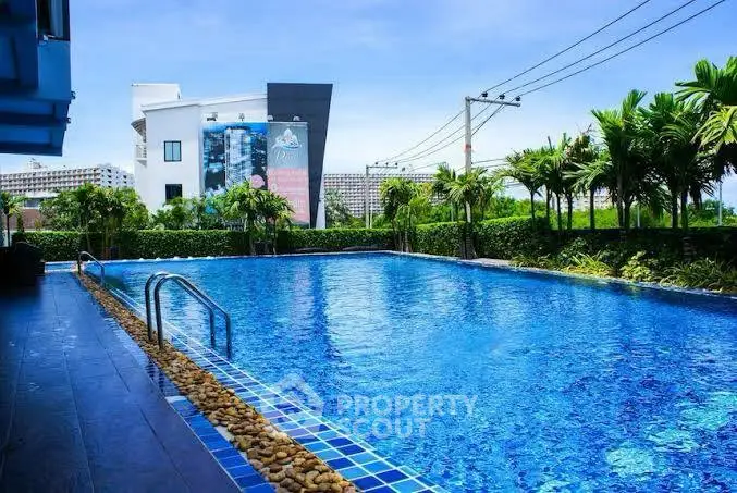 Luxurious outdoor swimming pool with lush greenery and modern architecture, perfect for relaxation and leisure.