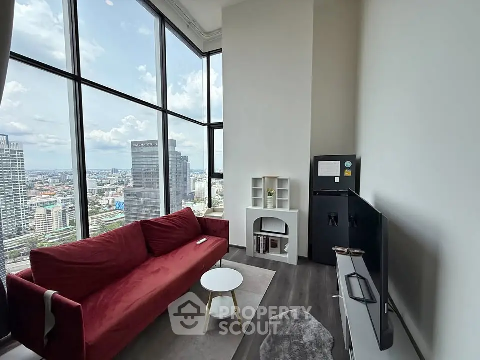 Modern living room with stunning city view and red sofa