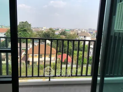 Stunning balcony view overlooking a vibrant cityscape with lush greenery and urban charm.