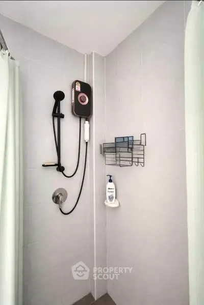 Modern bathroom shower area with sleek fixtures and wall-mounted storage.
