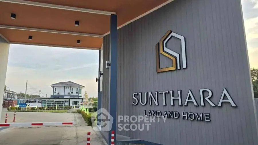 Modern gated entrance of Sunthara Land and Home with stylish architecture.
