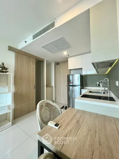 Modern kitchen with sleek design and integrated appliances in a stylish apartment.