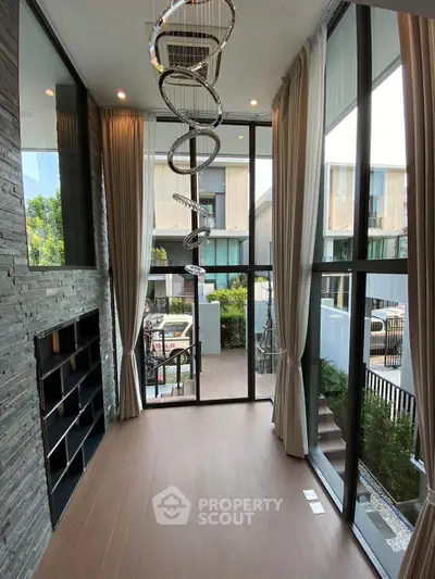 Luxurious modern living room with high ceilings and elegant chandelier