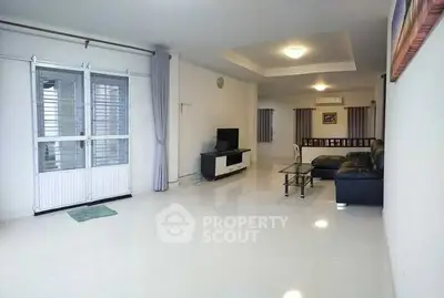 Spacious modern living room with sleek furniture and bright lighting