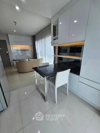 Modern open-plan kitchen and living area with sleek design and natural light