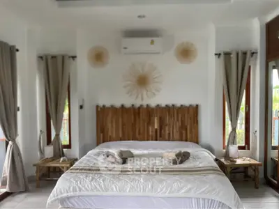 Luxurious bedroom with stylish decor and natural light, perfect for relaxation.