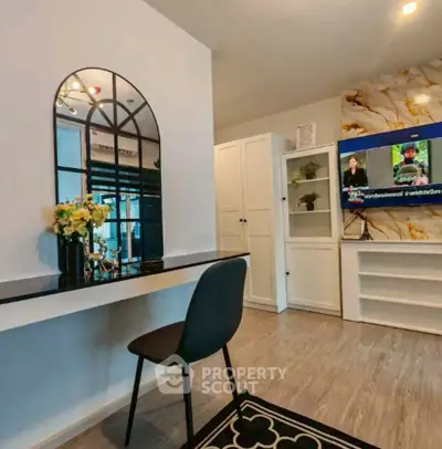 Modern living room with stylish decor and wall-mounted TV