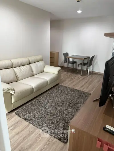 Modern living room with cozy sofa and dining area, perfect for relaxation and entertainment.