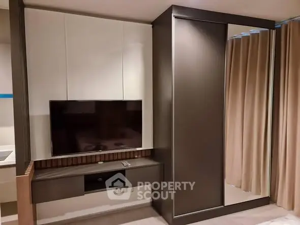 Modern living room with sleek TV setup and stylish storage solutions.