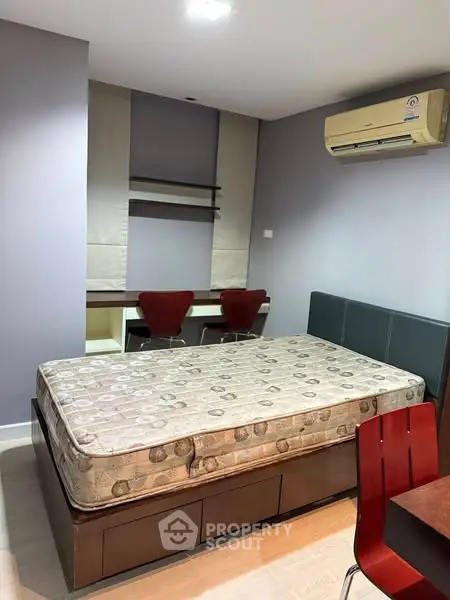 Cozy bedroom with modern furniture and air conditioning, perfect for comfortable living.