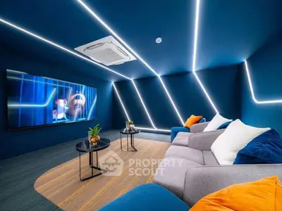 Modern living room with sleek design, featuring ambient lighting and a large flat-screen TV, perfect for entertainment.