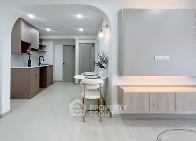 Modern open-layout kitchen and dining area with sleek design and neutral tones.