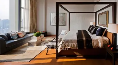 Luxurious bedroom with modern decor and large windows offering natural light.