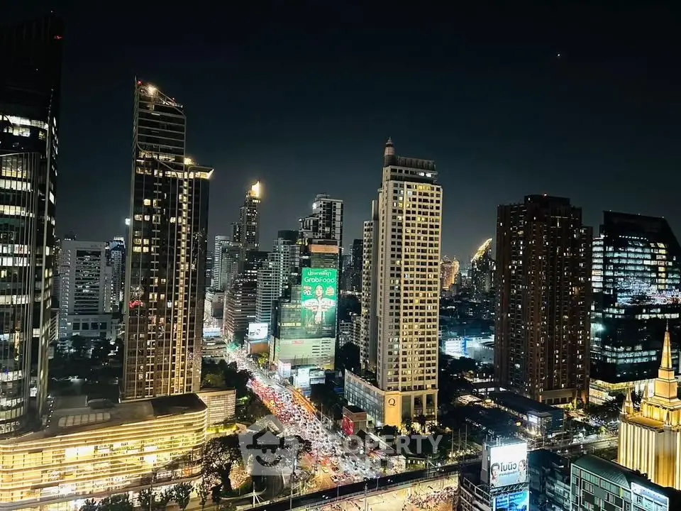 Stunning nighttime cityscape view of illuminated skyscrapers and bustling streets in a vibrant urban setting.