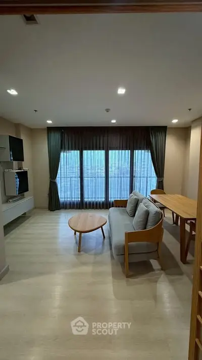 Spacious living room with modern furniture and large windows for natural light.