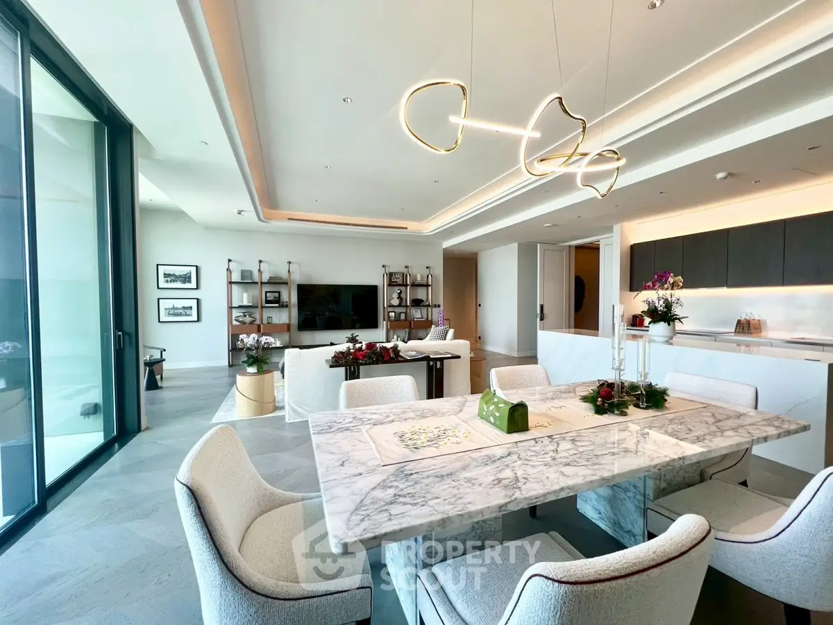 Luxurious open-plan living and dining area with modern lighting and elegant marble table.