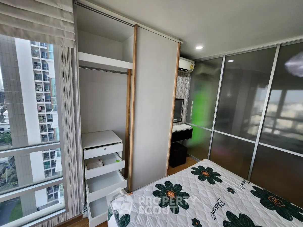 Modern bedroom with built-in wardrobe and city view