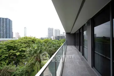 Spacious balcony with stunning cityscape and lush greenery views