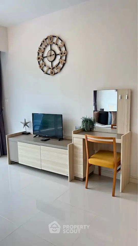 Modern living room with stylish furniture and wall clock