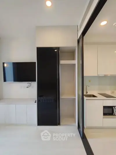 Modern apartment interior with sleek kitchen and built-in storage