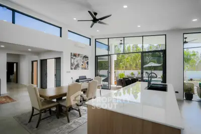 Spacious modern living room with open kitchen and large windows