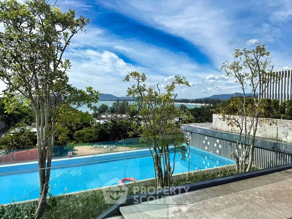 Luxurious rooftop pool with stunning ocean view and lush greenery