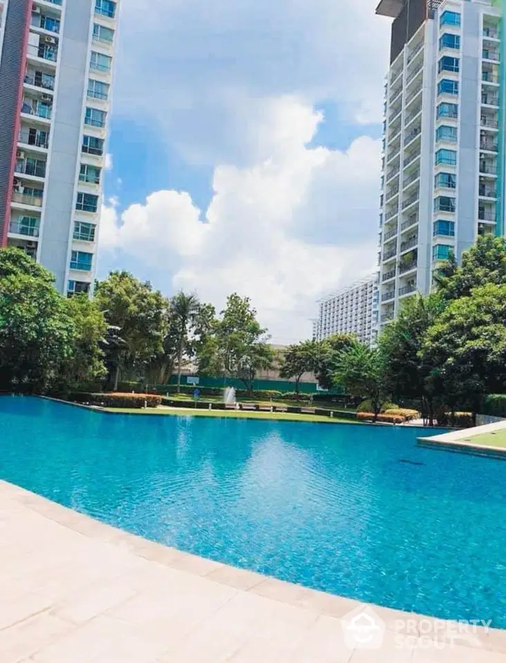 Luxurious residential complex with stunning pool and modern high-rise buildings.