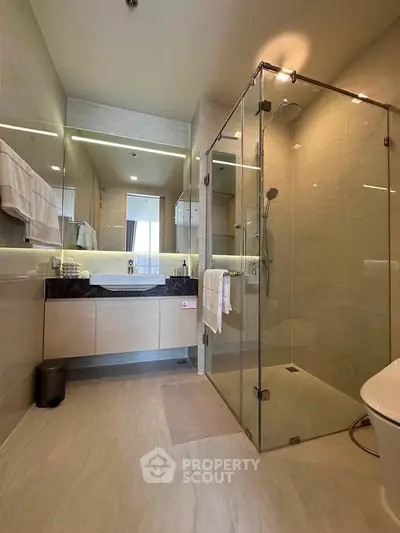 Luxurious modern bathroom with glass shower and elegant fixtures