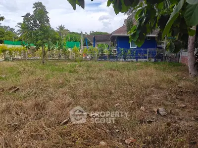 Charming countryside property with lush garden and vibrant blue house exterior.
