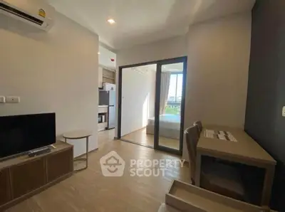 Modern apartment interior with open layout, featuring a cozy living area and stylish furnishings.