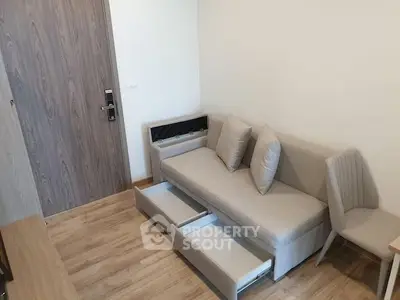 Modern living room with stylish sofa and storage drawers, perfect for compact spaces.