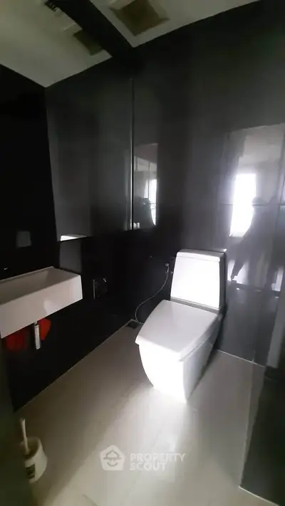 Modern bathroom with sleek black tiles and contemporary fixtures