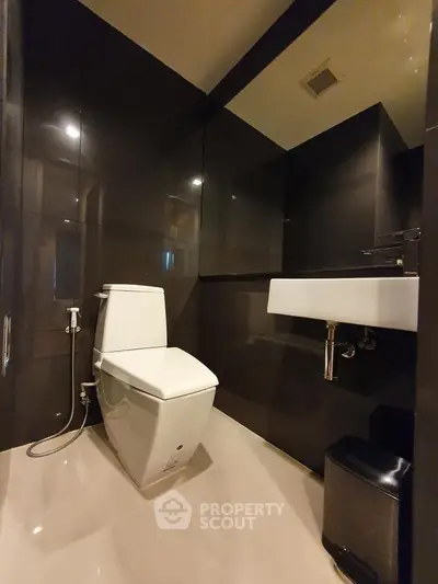 Modern bathroom with sleek black tiles and contemporary fixtures