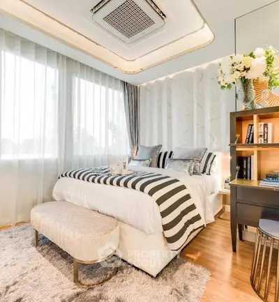 Luxurious bedroom with elegant decor and natural light, featuring plush bedding and stylish furnishings.